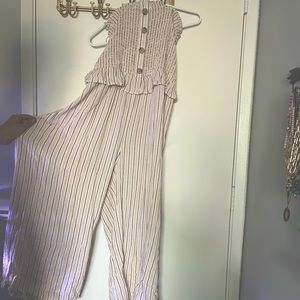 Sleeveless tube top jumpsuit. Pin stripes. Button details. Wide legs.